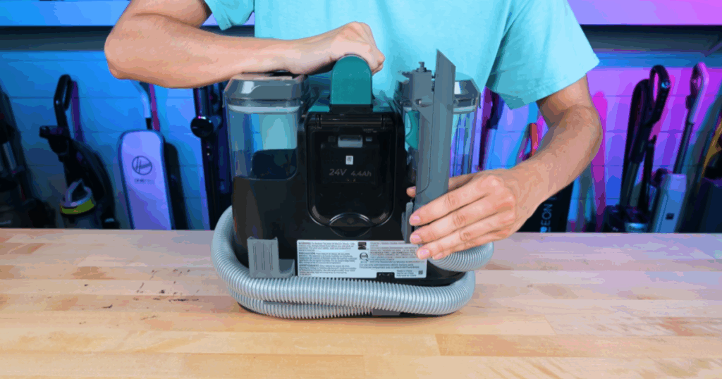 Vacuum Wars evaluating hose management on portable carpet cleaners, showing how each model’s storage system wraps and secures the hose and handle for easy organization.
