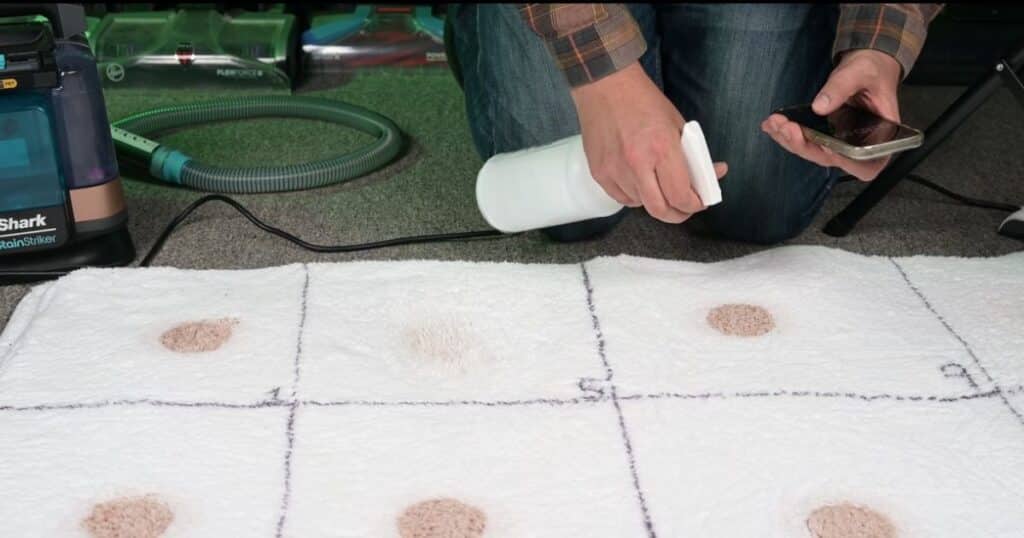 Pre-treating a carpet stain before usu=ing a portable spot cleaner.