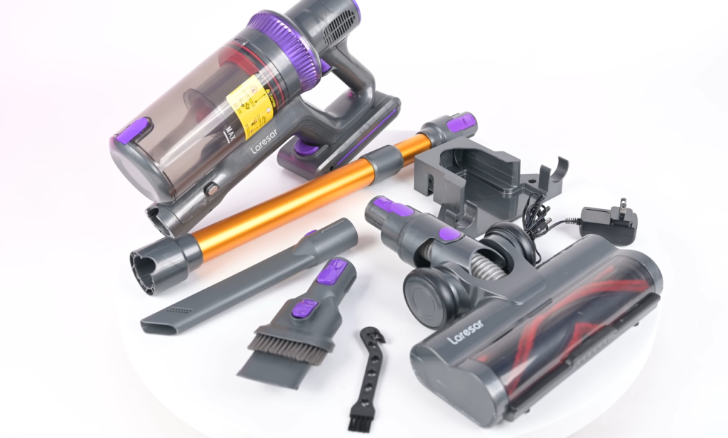Laresar Elite 3 vacuum with its array of attachments displayed, including a crevice tool, dusting brush, upholstery tool, and wall mount