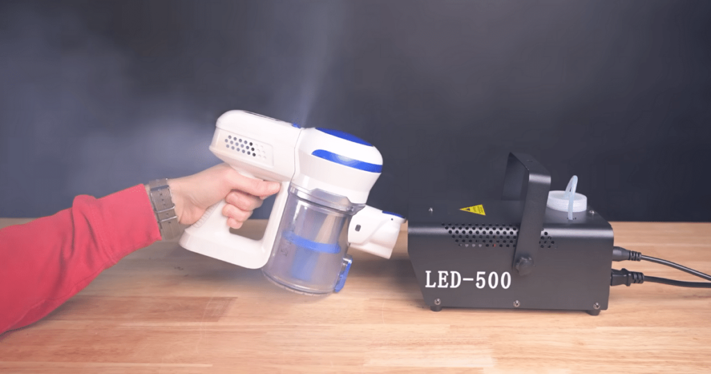 A cordless vacuum being tested with fog.