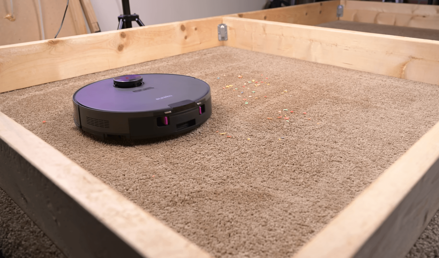 The E10S on a carpeted test area, surrounded by scattered multicolored particles