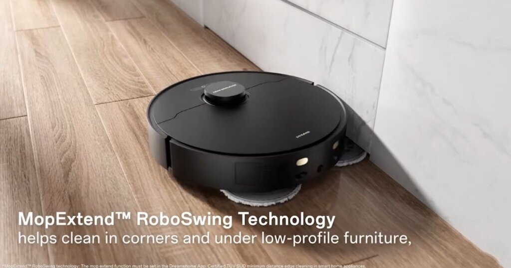 Dreame robot vacuum using MopExtend RoboSwing Technology to clean along a wall edge with spinning mop pads.