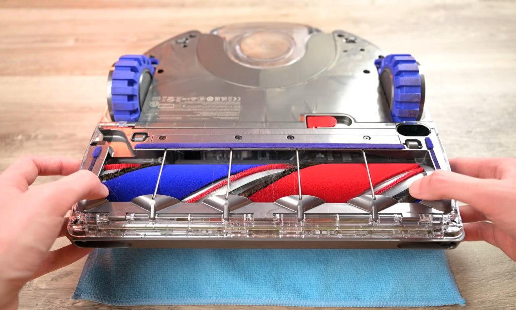 Close-up image of the underside of the Dyson 360 Vis Nav robot vacuum, showing its brush rolls free of hair entanglement after use.