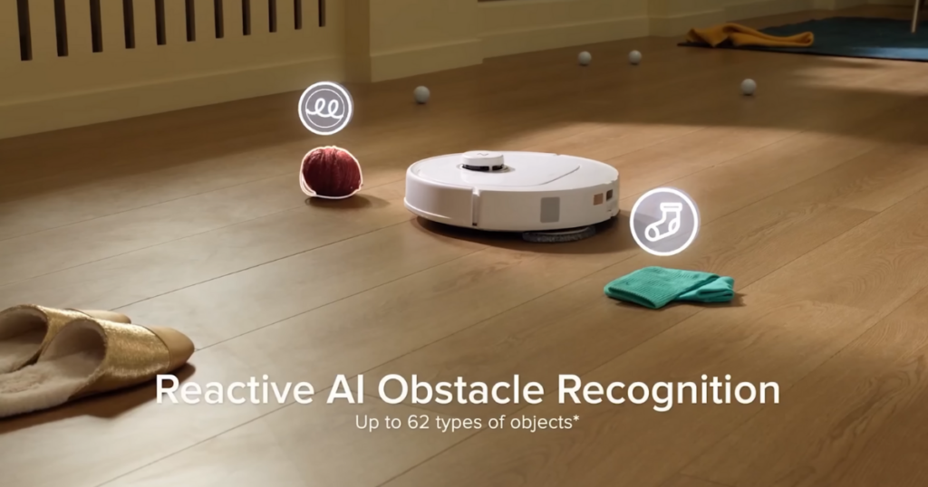 Roborock Q Revo MaxV robot vacuum navigating around various household objects on a wooden floor, showcasing its Reactive AI Obstacle Recognition feature.