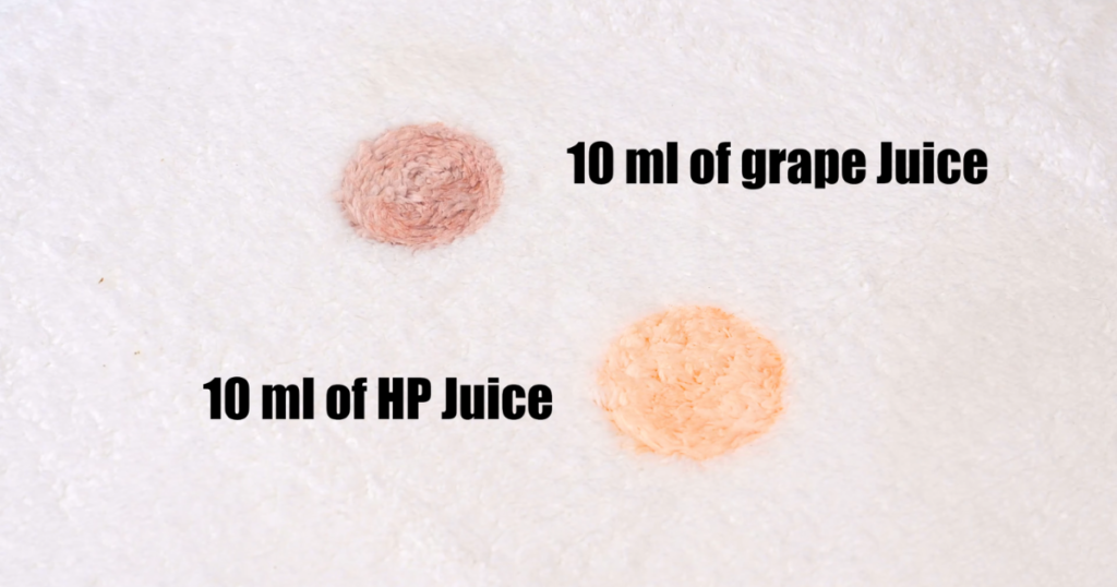 Two stains on a white carpet used in evaluations: one made with 10 ml of grape juice and the other with 10 ml of HP juice.