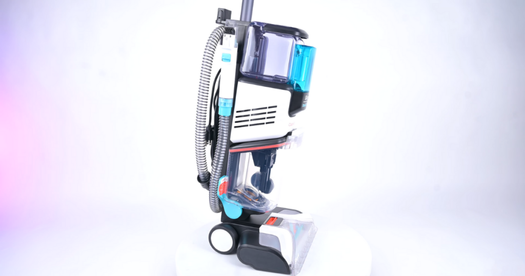 A side view of the Shark CarpetXpert carpet cleaner, highlighting its onboard hose attachment and various components.