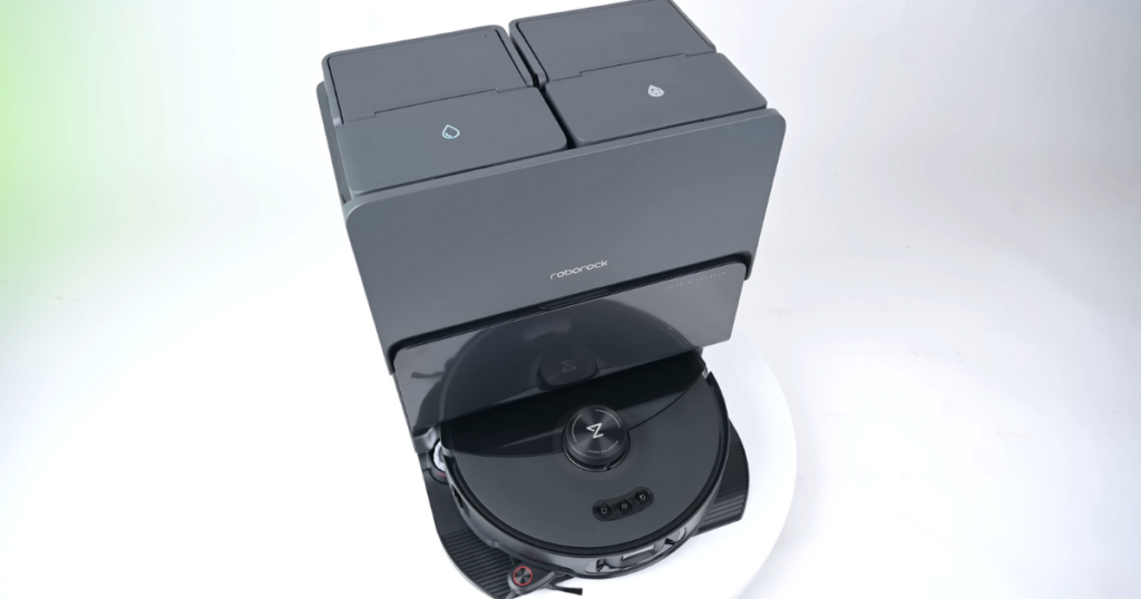 Top view of a Roborock S8 Max robot vacuum series in its docking station. The station has two compartments on top, each labeled. The docking station and robot vacuum are showcased against a white background.