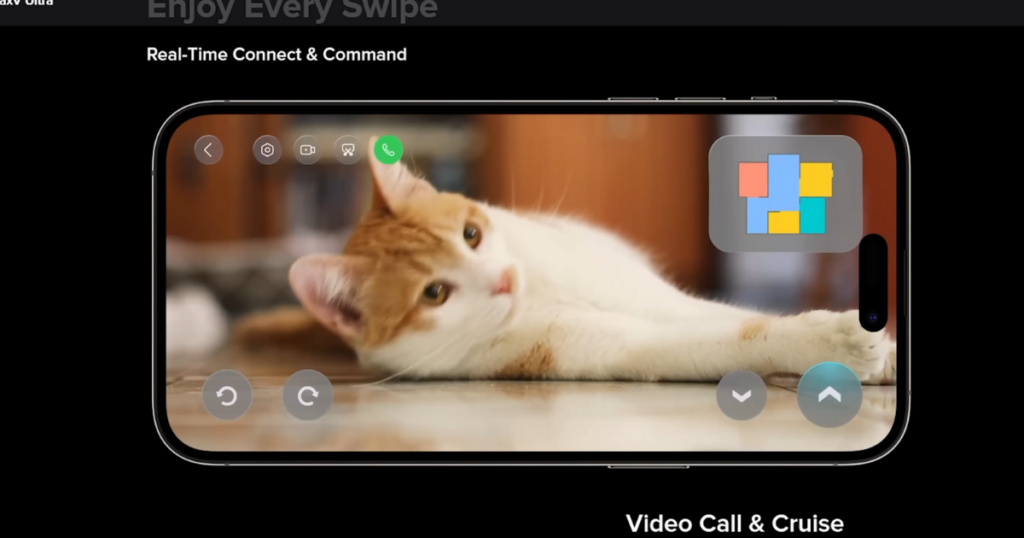 A smartphone screen displaying a live video feed of a cat lying on the floor, as seen through the Roborock app. The interface shows real-time connect and command features, including video call, camera, and movement controls.