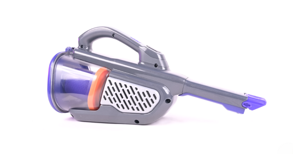 A side view of the Black+Decker Furbuster handheld vacuum, featuring a gray and purple design, on a white background.