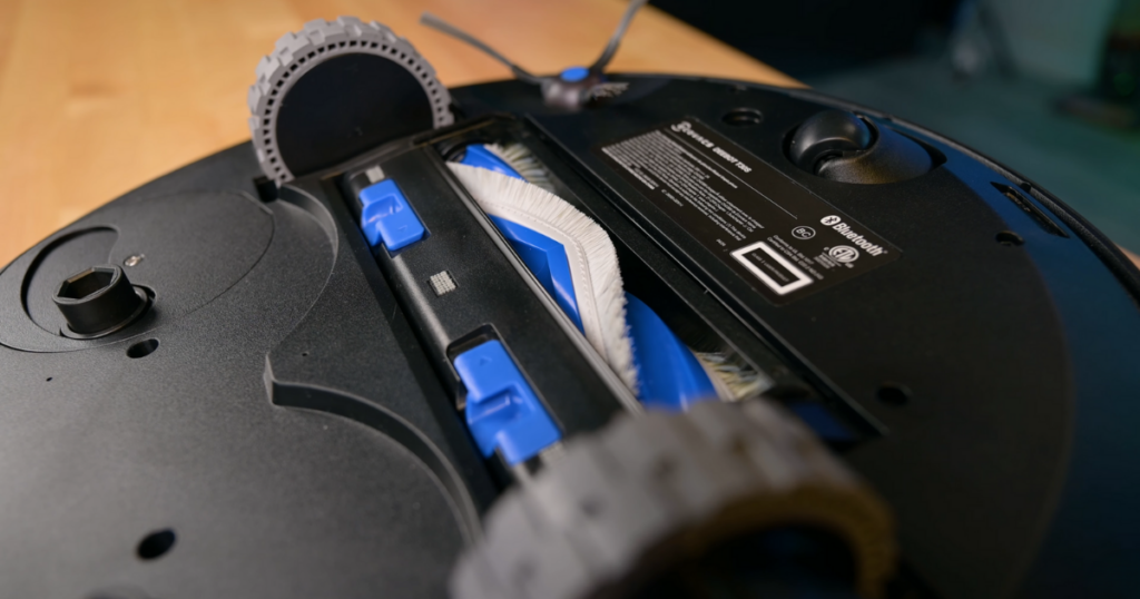 Close-up view of the T30S robot vacuum's underside, highlighting the brush roll and wheels.