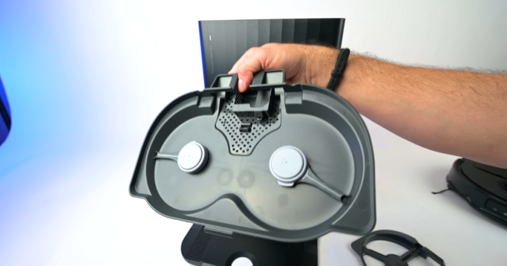 A person holding the Roborock Qrevo Master's docking station removable tray.