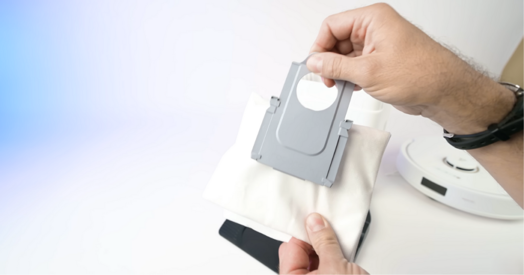 A close-up of a person’s hands holding a dust bag that is compatible with the Roborock S8+ and Q8 Max+ auto-empty bin system.