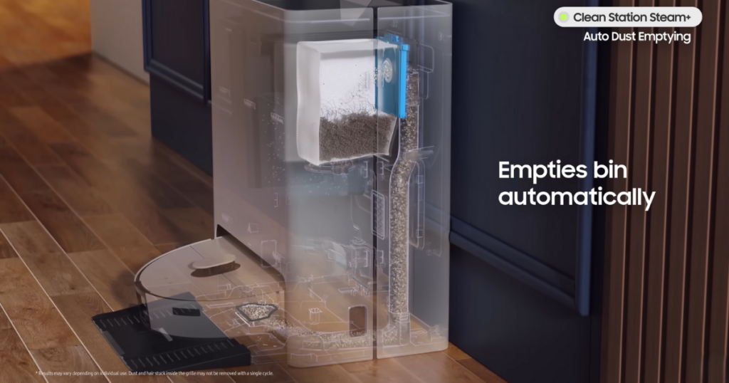 A visualization of the Samsung Bespoke Jet Bot AI Combo’s cleaning station with a cutaway view showing the automatic dustbin emptying mechanism on a hardwood floor.