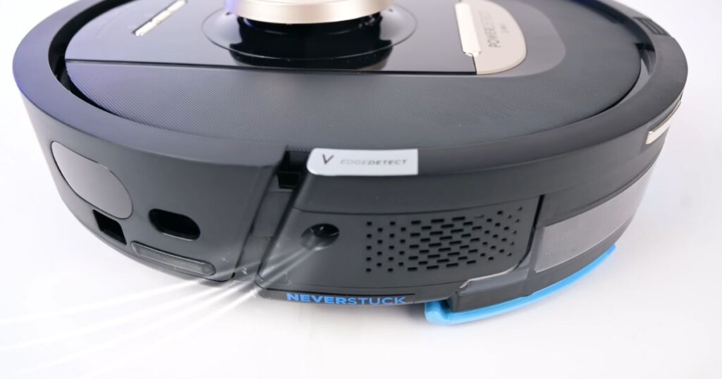 Close-up of the Shark NeverTouch Pro robot vacuum highlighting its EdgeDetect and NeverStuck features.