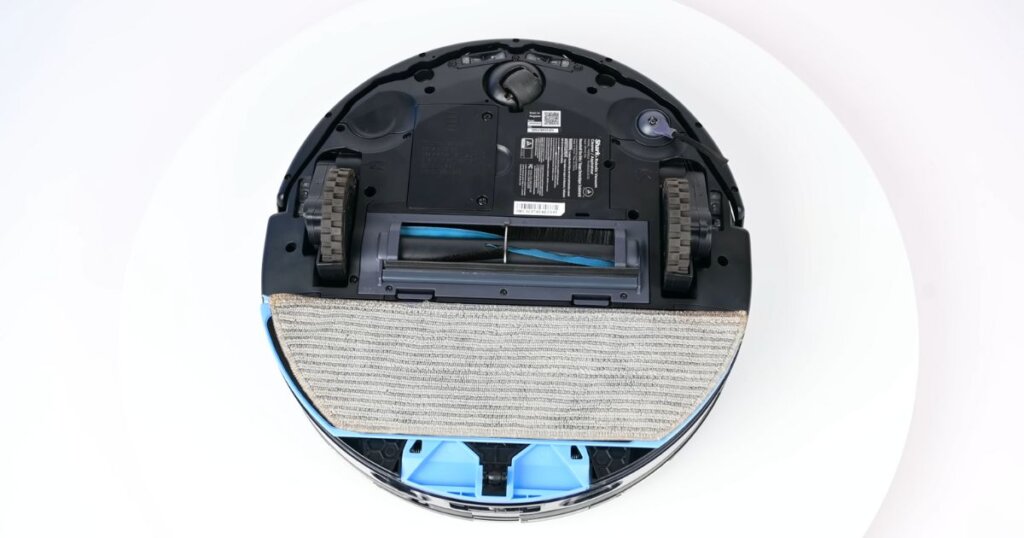 Bottom view of the Shark NeverTouch Pro robot vacuum, showing its mop pad, brush roll, wheels, and sensors.