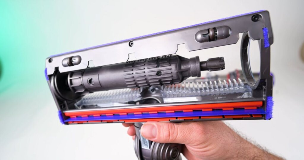 Close-up of the underside of the Dyson Digital Slim brush head showing the anti-hair tangle comb design inside the roller housing.