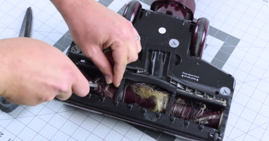 Removing hair from an uptight vacuums brush roll.