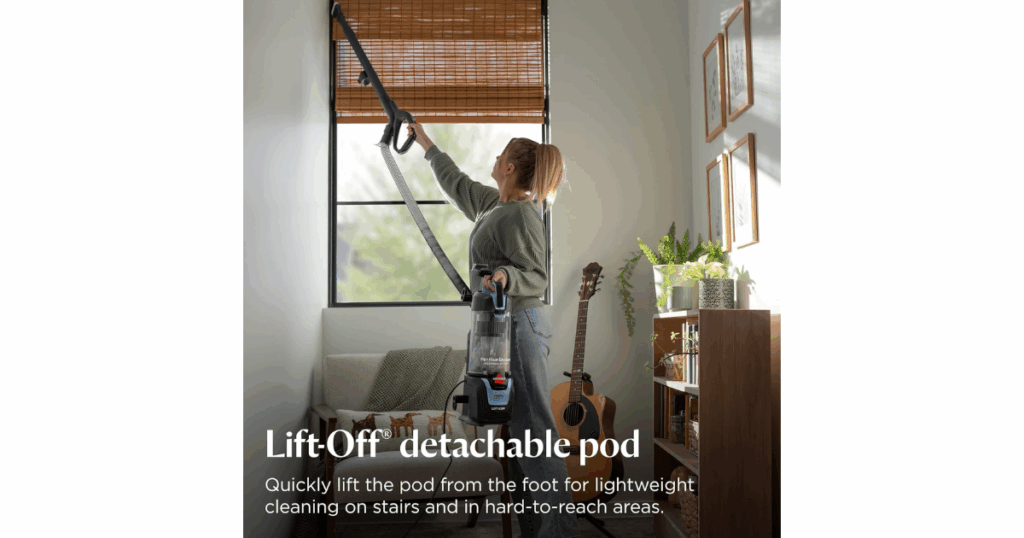 A woman vacuuming window blinds with the Bissell Pet Hair Eraser Allergen Lift-Off Pod
