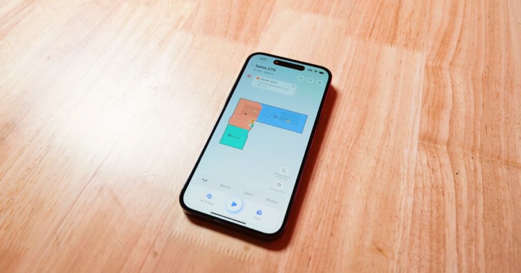 Smartphone screen showing the Roborock Saros Z70 app interface with mapped cleaning zones.