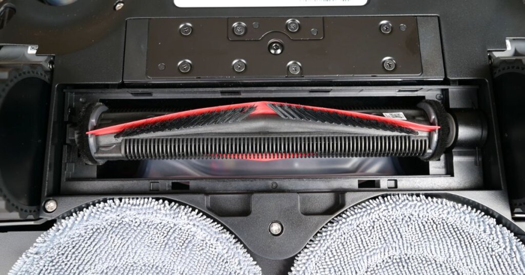 Close-up view of the Roborock Z70’s Free-Flow main brush and dual spinning mop pads from underneath the unit.