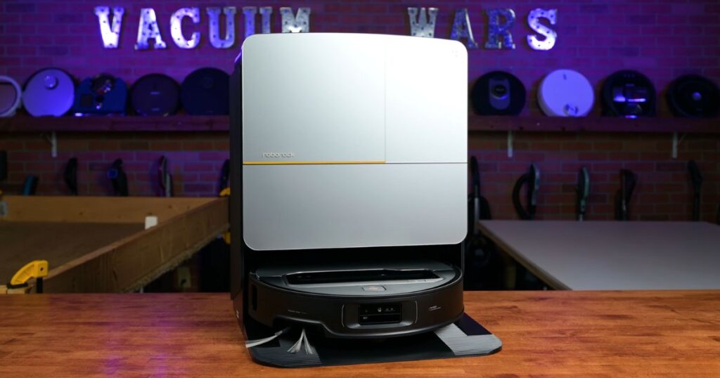 Roborock Saros Z70 shown docked in its multi-function base station, which supports self-emptying, mop washing, and hot-air drying.