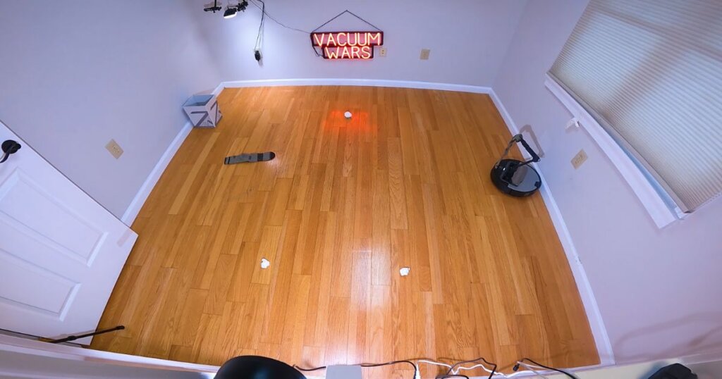 Test area with sock and paper balls on the floor, used to evaluate the Roborock Saros Z70’s object recognition and pickup arm.