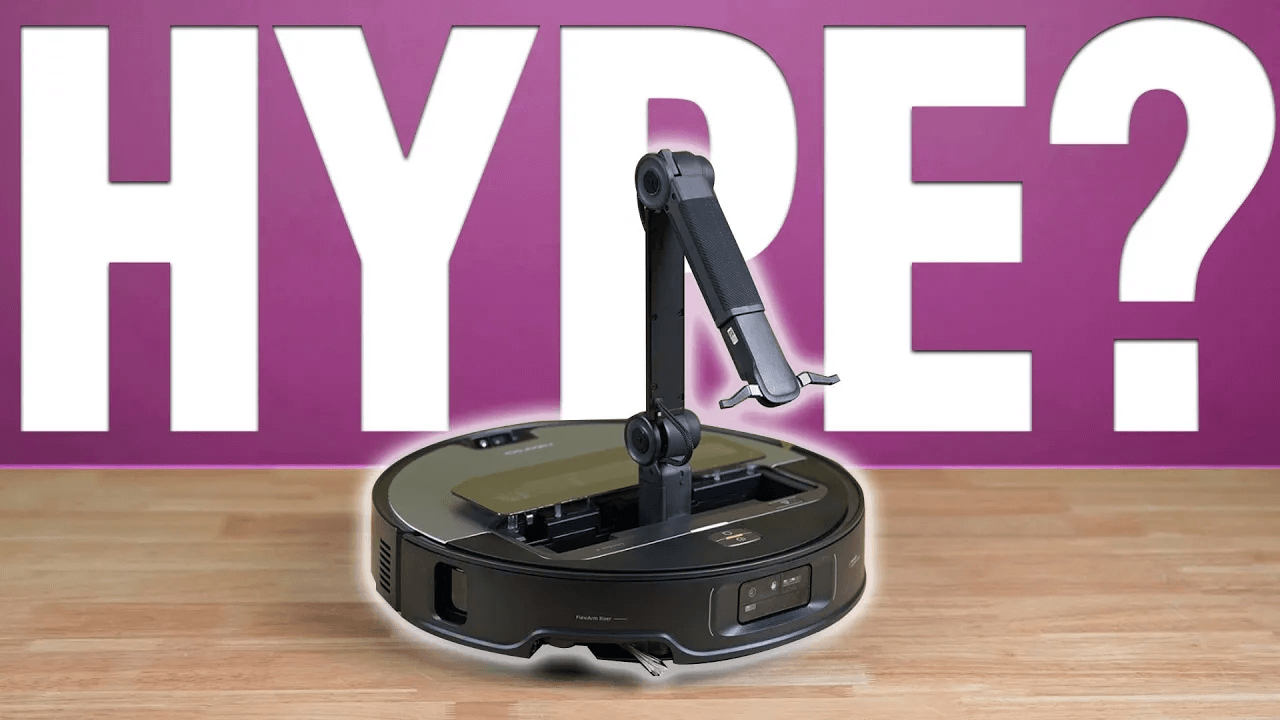 Roborock Saros Z70 robot vacuum with extended mechanical arm in front of a pink background with the word “HYPE?” in bold white text.