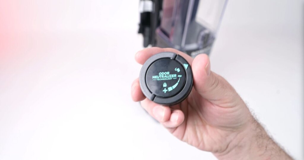 Close-up of Shark Rotator Pet ZU102 odor neutralizer cartridge with adjustable scent dial.