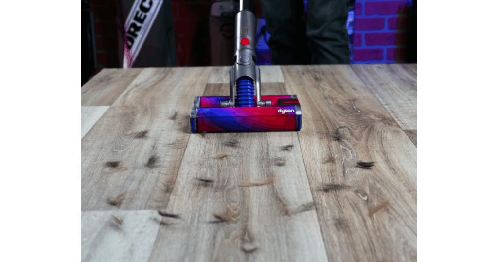 Vacuuming pet hair with a cordless vacuum.