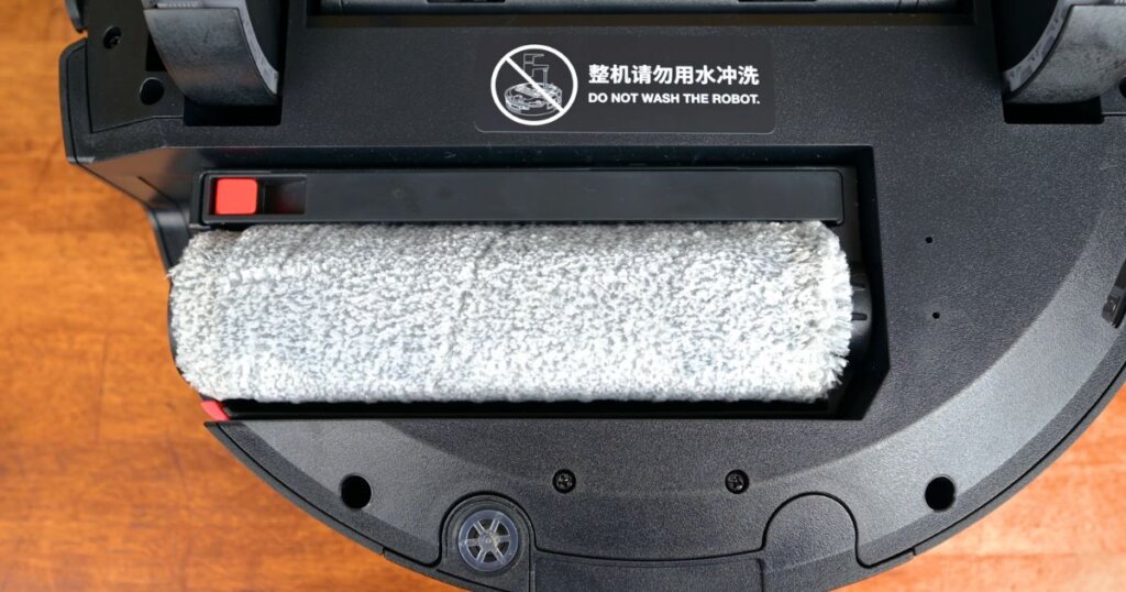 Close-up of the Yeedi S14 Plus roller-style mop attachment beneath the robot vacuum.