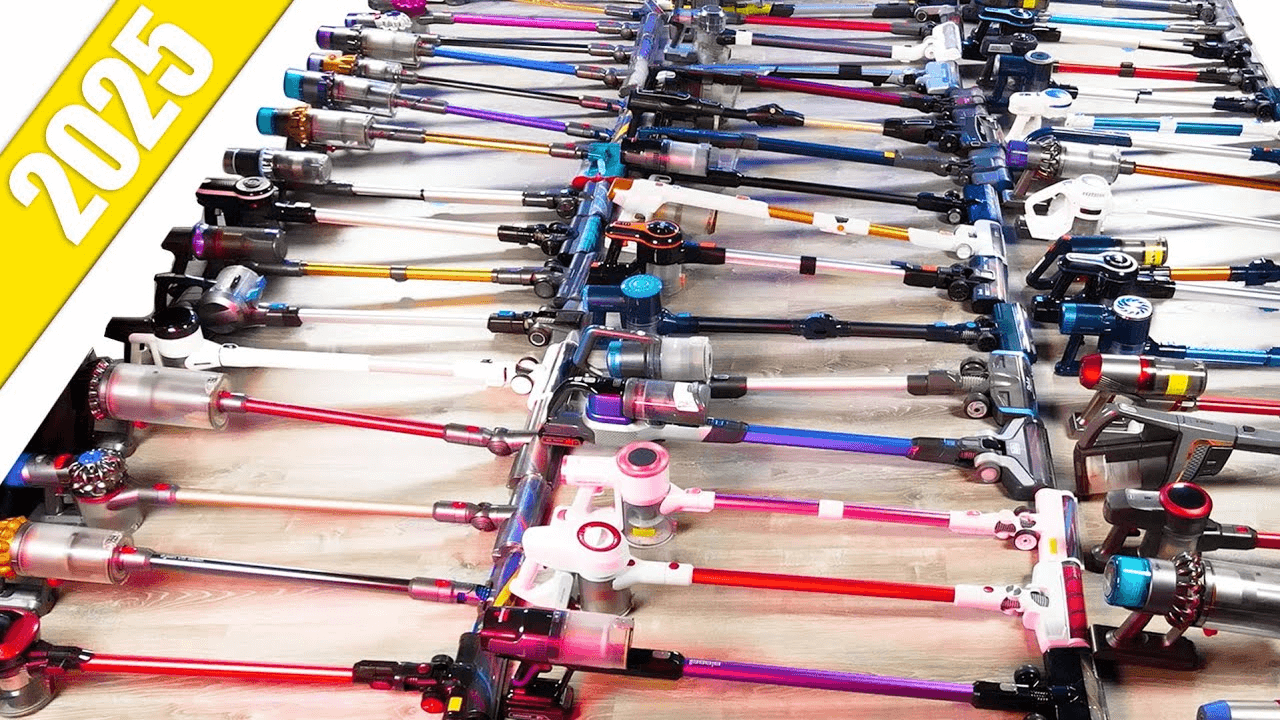Top-down view of dozens of cordless vacuums laid out in rows, showing a wide variety of brands and models.