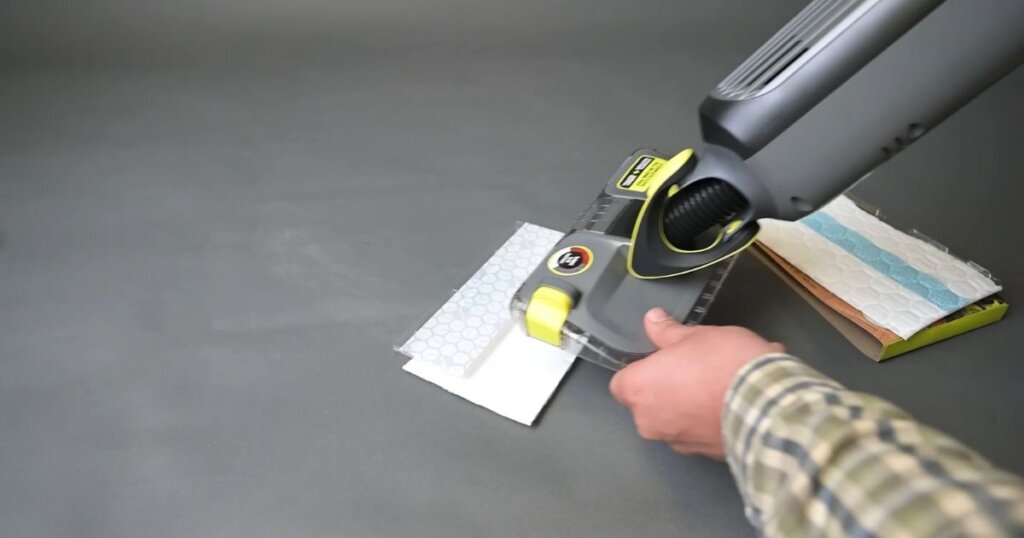 Shark VACMOP being aligned with a fresh disposable pad next to a pack of unused pads.