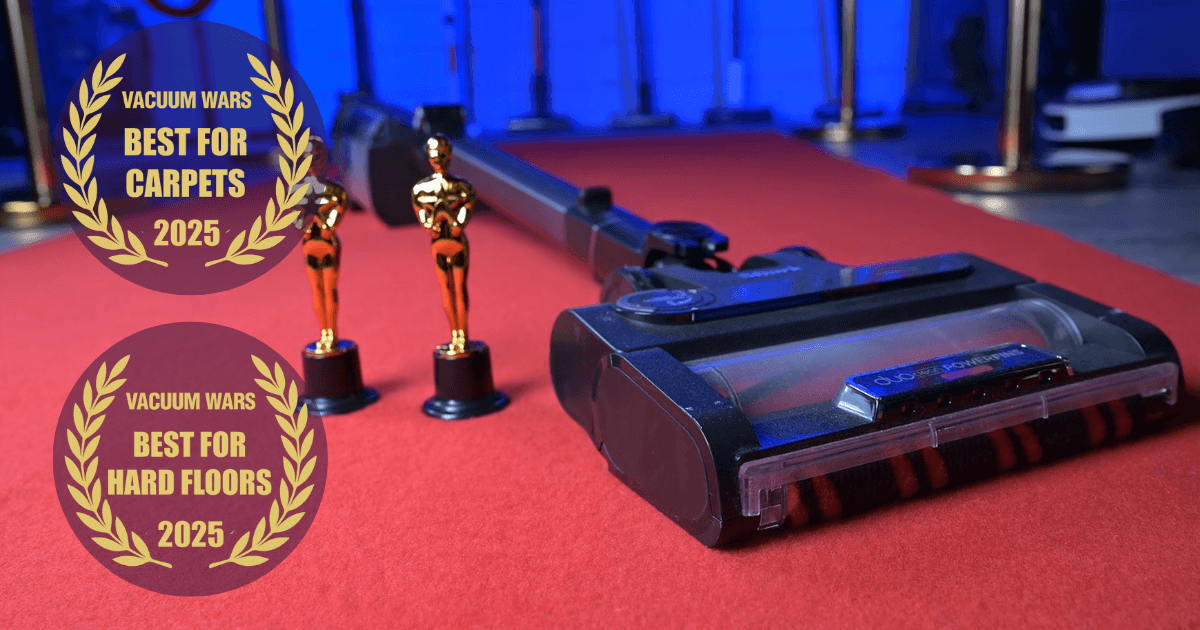 Shark Stratos cordless vacuum on a red carpet beside two trophy statues, with badges reading "Best for Carpets 2025" and "Best for Hard Floors 2025" from Vacuum Wars.