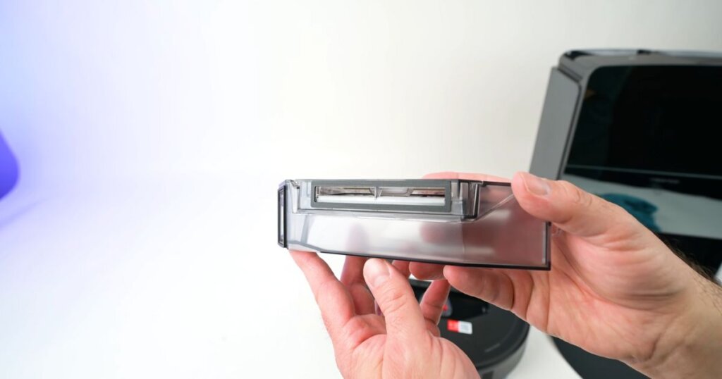 Close-up of a person holding the Roborock Saros 10R’s dustbin. The compact 270ml bin is visible, designed for robotic vacuum systems.