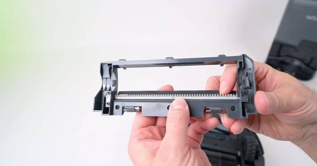 Close-up view of the Eufy E20 Pro Detangle Comb designed to remove hair from the brush automatically.