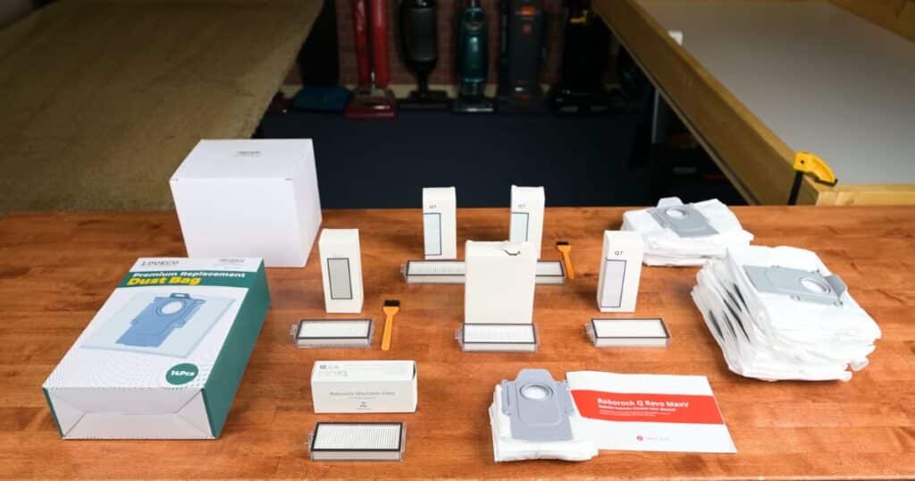 Roborock Q7 official and third-party robot vacuum replacement bags and filters on table for evaluation