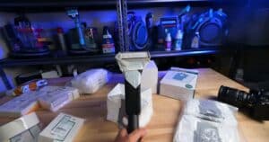 A handheld vacuum with a taped filter attachment prepared for fog testing against off-brand filters in a controlled environment.