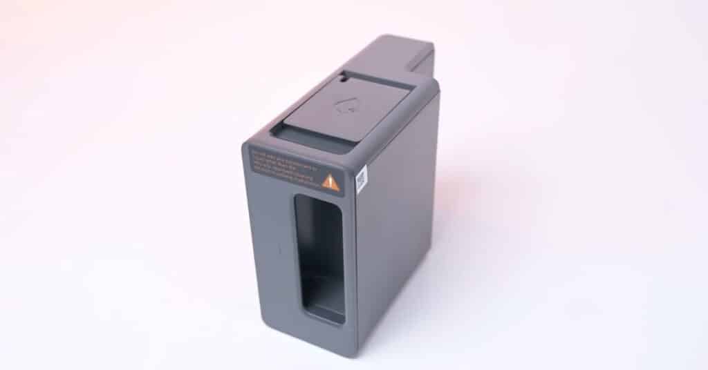 Dreame L50 Ultra mop solution reservoir in gray with caution label visible.