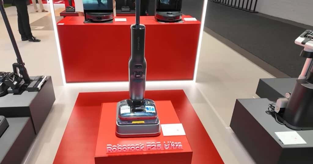 Roborock F25 Ultra hard floor cleaner presented on a red pedestal at IFA 2025 in Berlin.