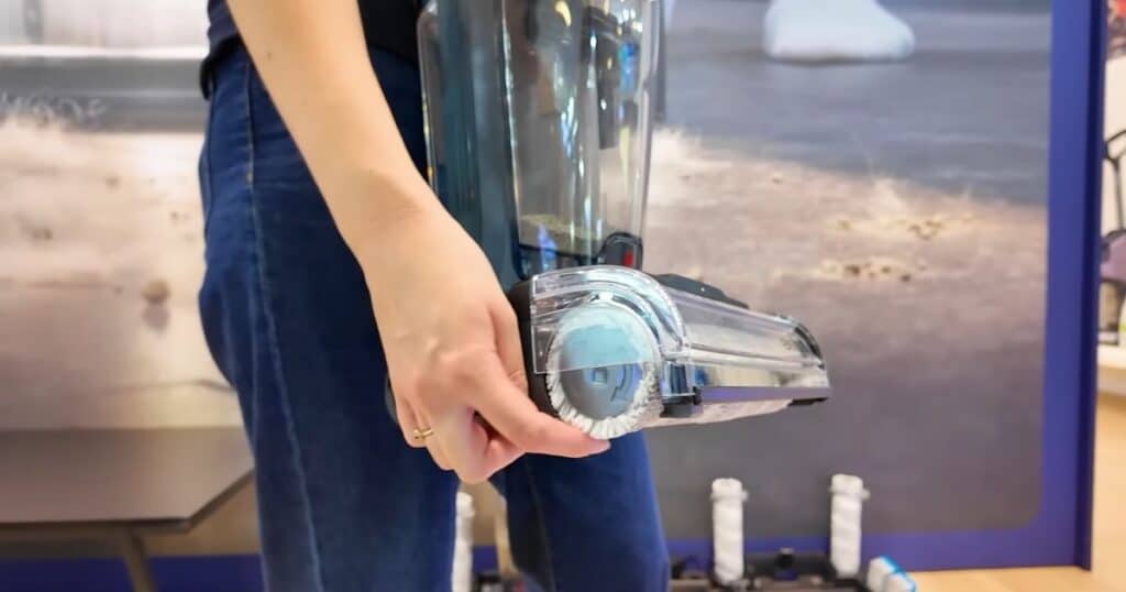 Close-up of the Bissell CrossWave Edge Find brush roll configuration with a hand holding the cleaning head at IFA 2025.
