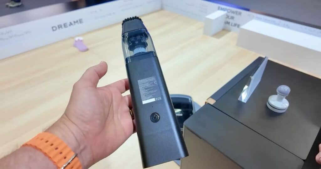 A hand holding Dreame Cyber10 Ultra’s mini vacuum cleaner attachment, part of the robotic arm system, at IFA 2025.