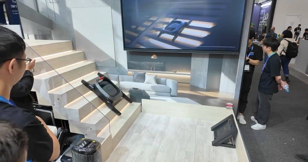 Eufy MarsWalker stair-climbing module at IFA 2025, climbing a set of white display stairs during a demonstration.