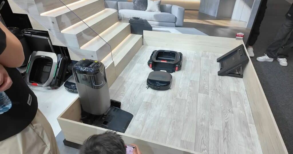 Eufy S2 Omni robot vacuum next to the MarsWalker stair-climbing module and docking station at IFA 2025.
