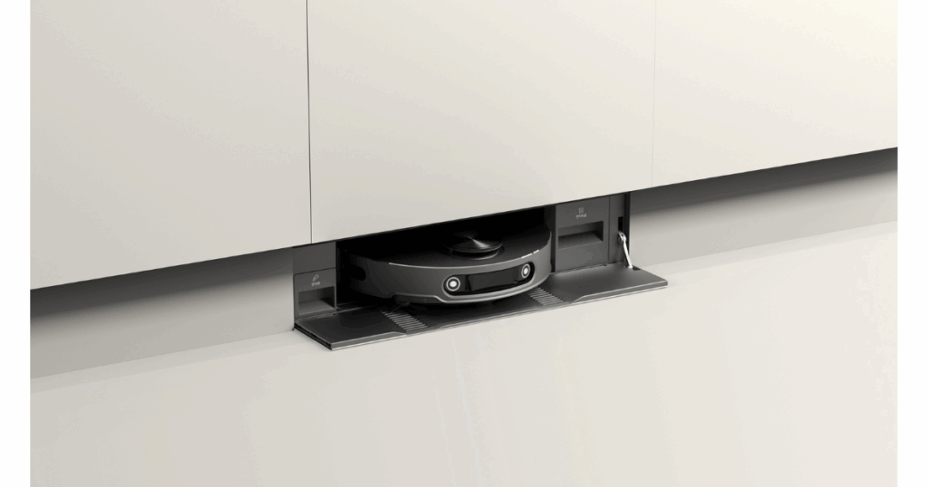 LG Robot Vacuum Under Mount | Vacuum Wars LG robot vacuum partially visible in a built-in docking bay under a kitchen cabinet toe-kick, with the stationโs side panels and ports exposed.