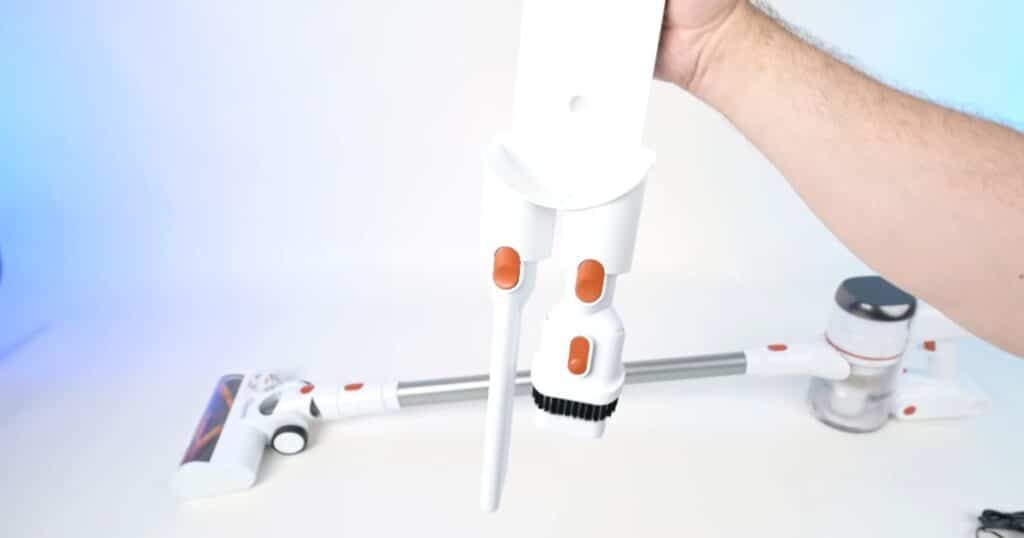 Tikom V500 cordless vacuum wall mount with charger connection and storage space for two included attachments.