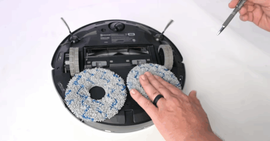Robot mop in the Vacuum Wars studio with dual spinning microfiber pads for scrubbing floors