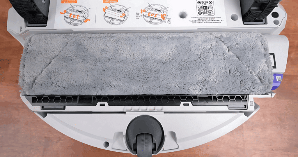 A close up of a track roller mop on the underside of a robot vacuum