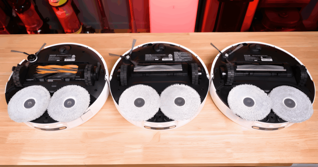 Underside view of a Dreame L40s robot vacuum showing the dual spinning mop pads used for stain removal and adjustable water-level mopping.