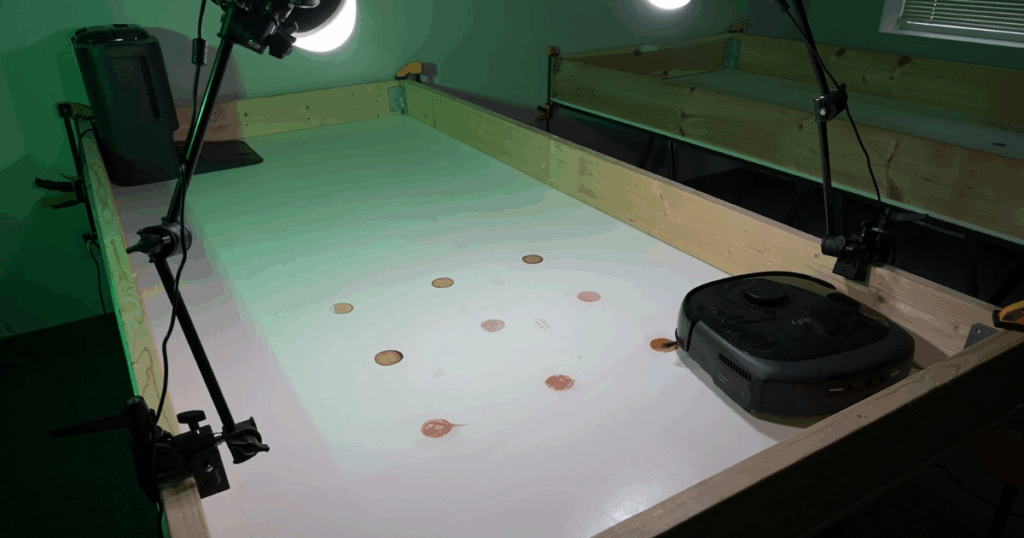 Eufy E20 Omni robot vacuum and mop starting the dried-on stain removal test in the Vacuum Wars studio.