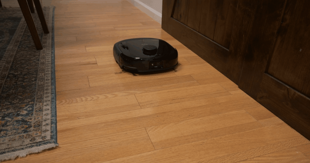 Eufy Omni E25 robot vacuum cleaning mixed flooring surfaces, demonstrating strong performance across hard floors and carpet.